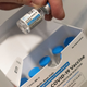 A pharmacist holds a vial of the Johnson & Johnson covid-19 vaccine at a hospital in Bay Shore, N.Y.